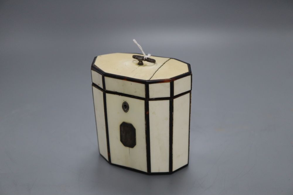 A George III octagonal ivory and tortoiseshell veneered tea caddy, height 10cm